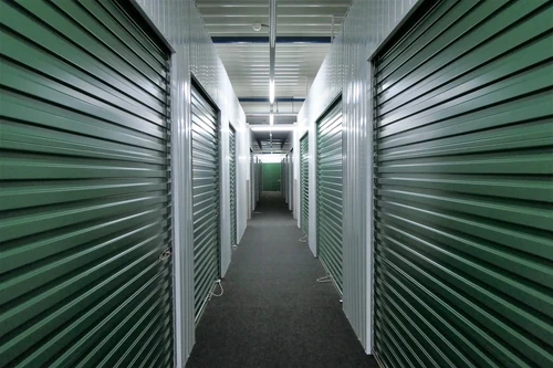 Storage unit hallway with green doors